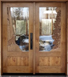 Carved door, howling wolf, trees and moon